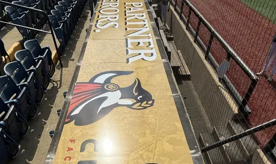 Black and gold penguin mascot and CITY WIDE logo on ACM dugout-top installation