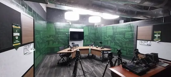 Empty UAB-branded athletic facility with custom printed green murals